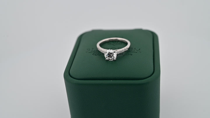 Luxurious platinum engagement ring with a 1.01ct lab grown diamond, symbolizing pure love, displayed elegantly on a green box.