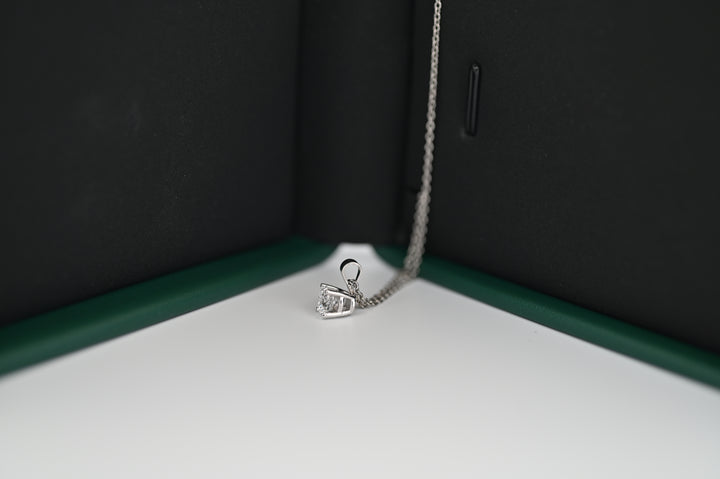 Ethernal Sparkle platinum pendant with 0.5 CT lab-grown diamond, elegantly displayed in a jewelry box.