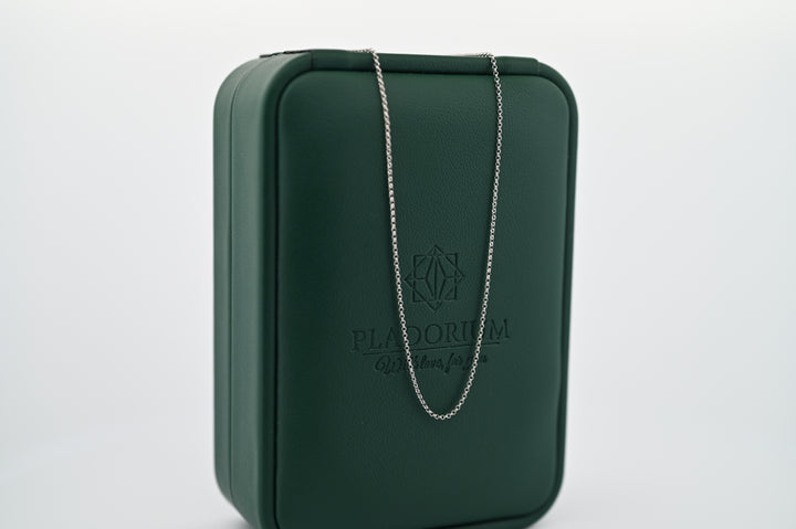 Lanț fin din platină Pladorium, 1mm, pe fundal elegant verde, simbol al rafinamentului și durabilității, cadou premium pentru femei.