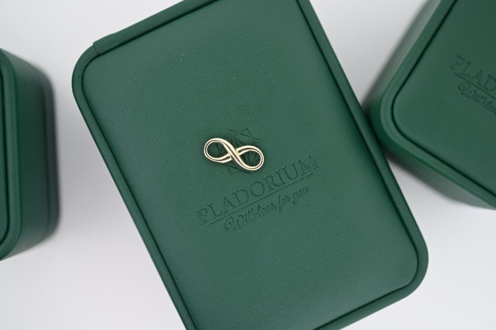 Luxurious Pladorium green box with elegant infinity symbol, showcasing premium craftsmanship.